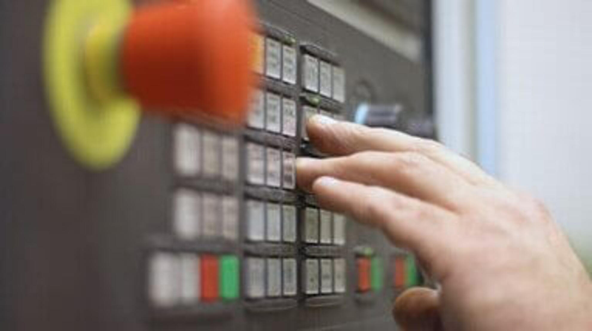 Silbitz Group Innovative Lösungen Eine Hand bedient eine Maschine mit vielen Knöpfen.